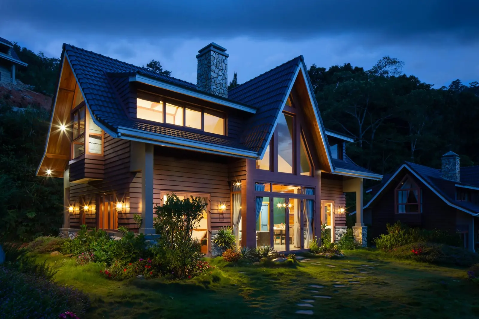 Foundation shrubs and a lawn in front of a house in the evening. Illustrative photo.